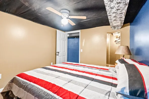 a bedroom with a bed and a lamp