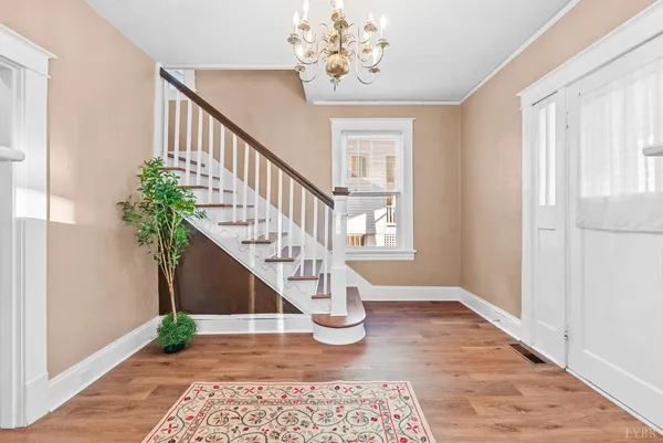 a view of entryway with wooden floor and a chandelier