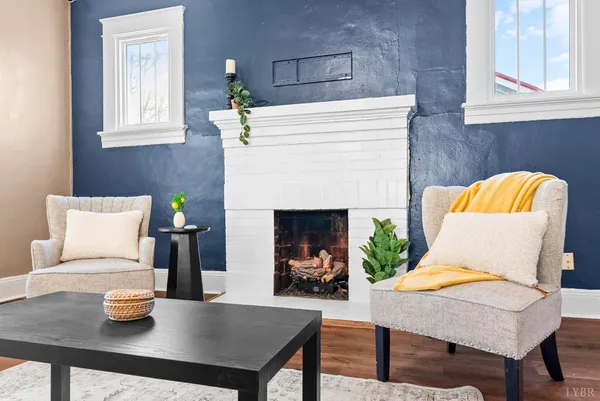 a living room with furniture and a fireplace