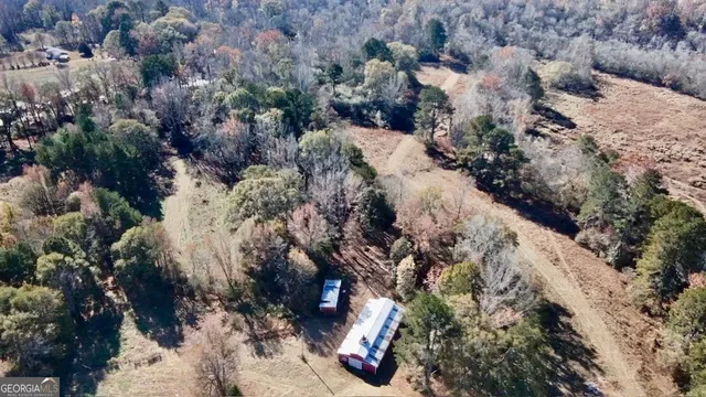 a view of a house with a yard covered in snow