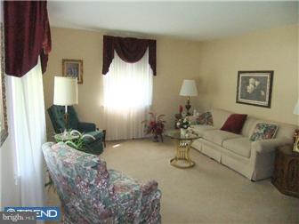 361 Garden Road Springfield, PA 19064 - Photo 3 of 12 a living room with furniture and a fireplace