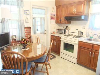 361 Garden Road Springfield, PA 19064 - Photo 4 of 12 a kitchen with a stove a sink and a refrigerator