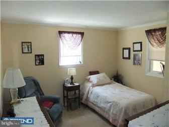 361 Garden Road Springfield, PA 19064 - Photo 5 of 12 a bedroom with a bed and a window
