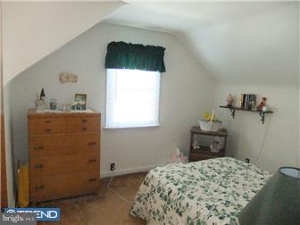 361 Garden Road Springfield, PA 19064 - Photo 7 of 12 a bedroom with a bed and a dresser in it