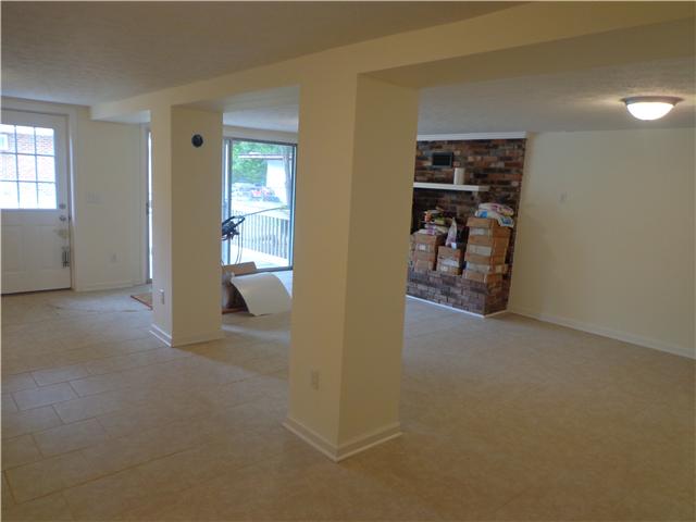 318 Jackson Road Portland, TN 37148 - Photo 2 of 18 Brand new Rec Room with Brick Fireplace...Sliding Glass Doors go out to small covered patio