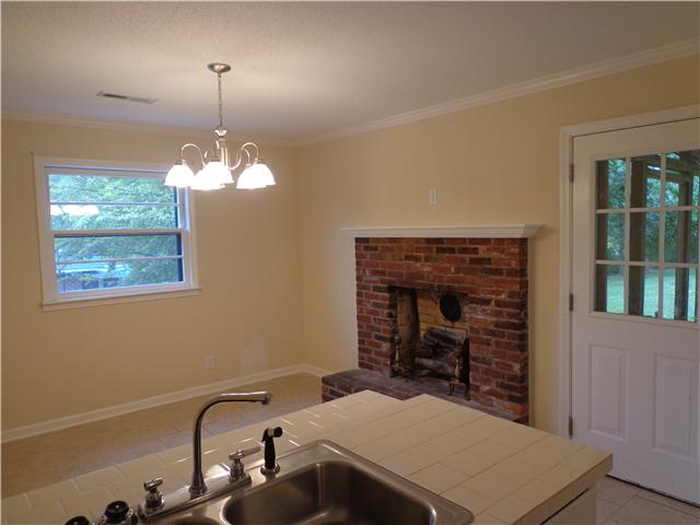 318 Jackson Road Portland, TN 37148 - Photo 6 of 18 Eat-in Kitchen with Brick Fireplace. Door exits to huge covered patio