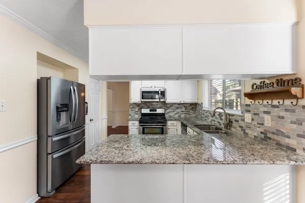 a kitchen with a refrigerator and a sink