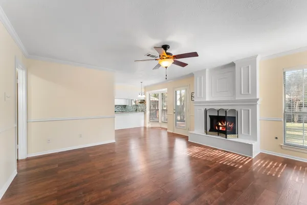 a view of a livingroom with a fireplace and window