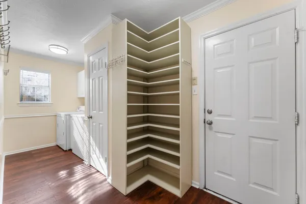 a view of a hallway with wooden floor and entryway