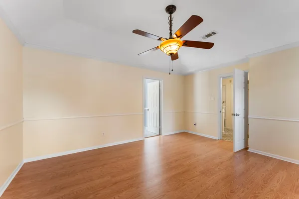 a bathroom with a sink a toilet a mirror and shower