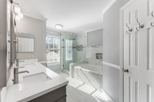 a bathroom with a shower sink and mirror