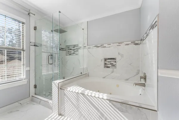 a bathroom with a granite countertop sink a toilet a large mirror and shower
