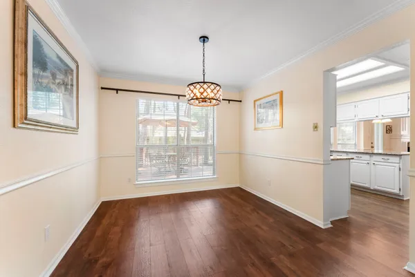 a dining room with chandelier wooden floor and a chandelier
