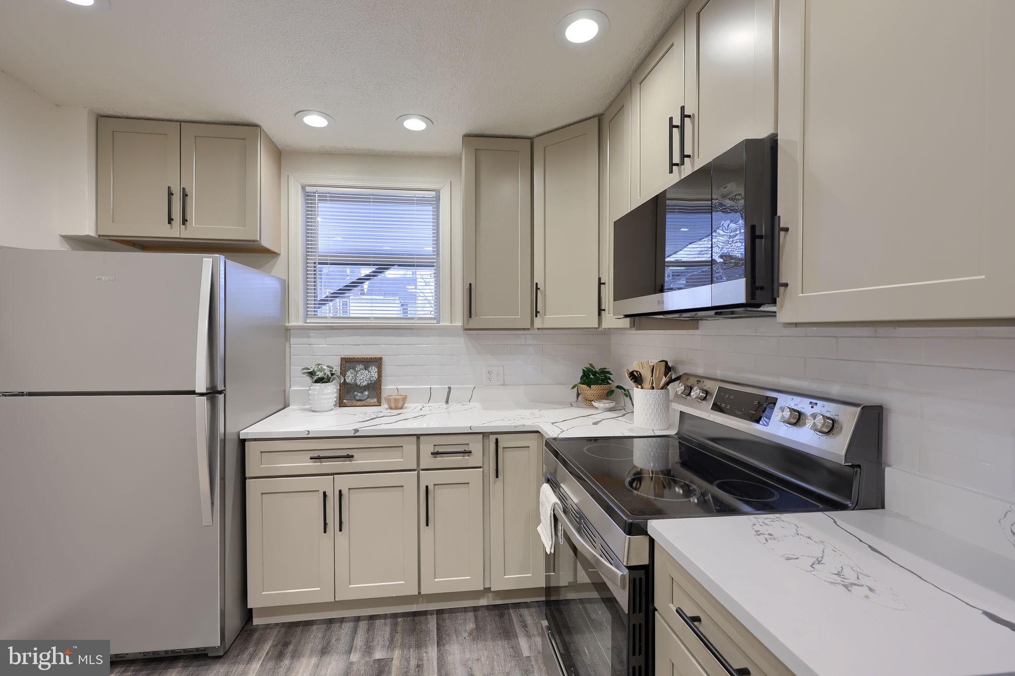 528 High Street Lancaster, PA 17603 - Photo 12 of 32 a kitchen with a sink a stove a refrigerator and cabinets
