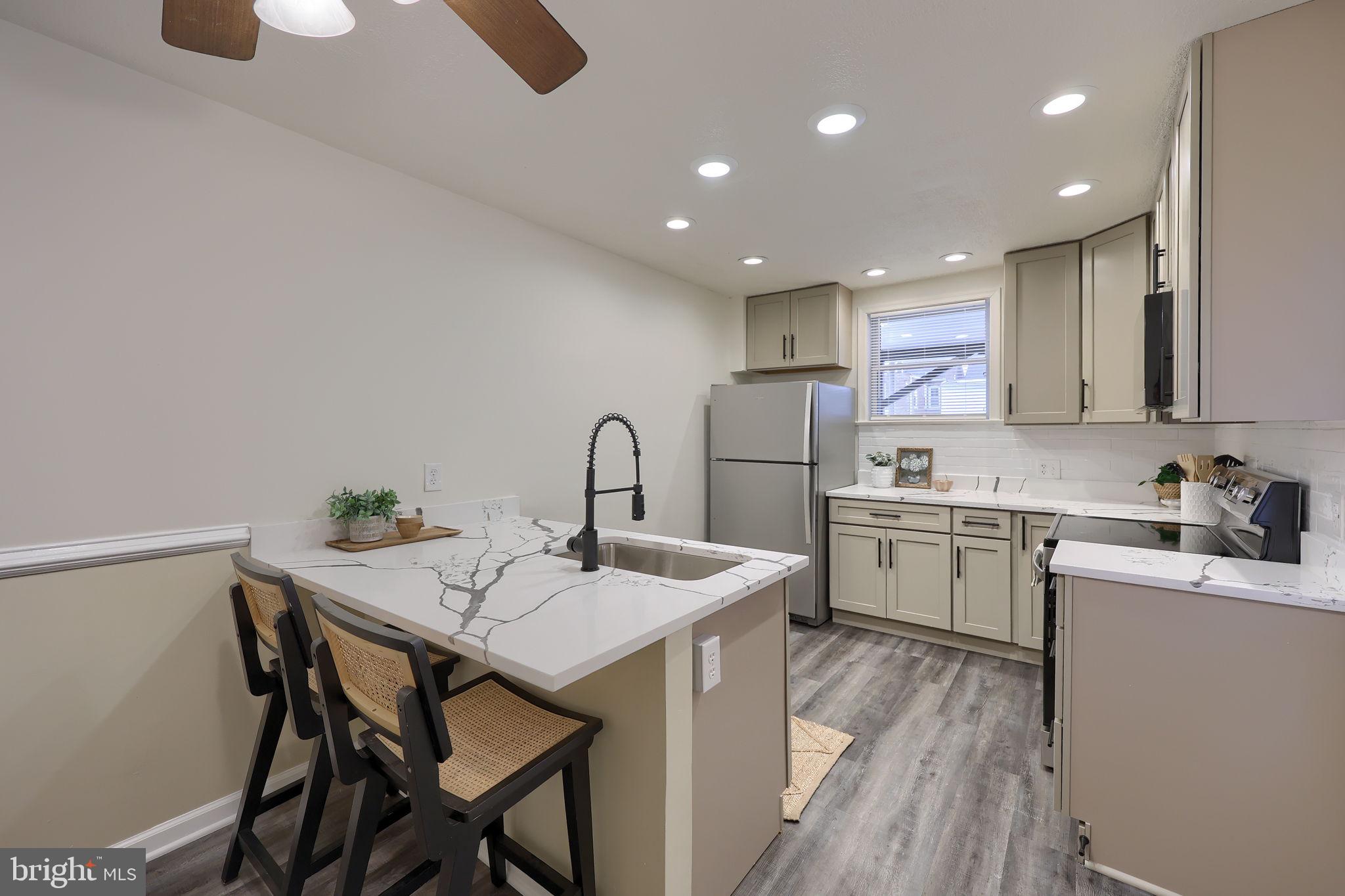 528 High Street Lancaster, PA 17603 - Photo 10 of 32 a kitchen with a table chairs sink and cabinets
