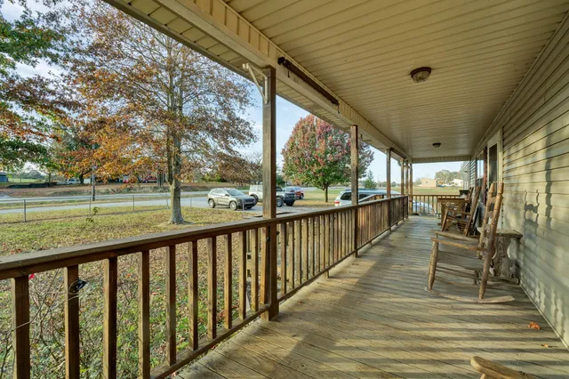 a view of a balcony with wooden floor