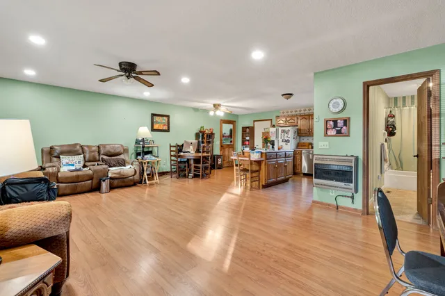 a living room with furniture and a wooden floor