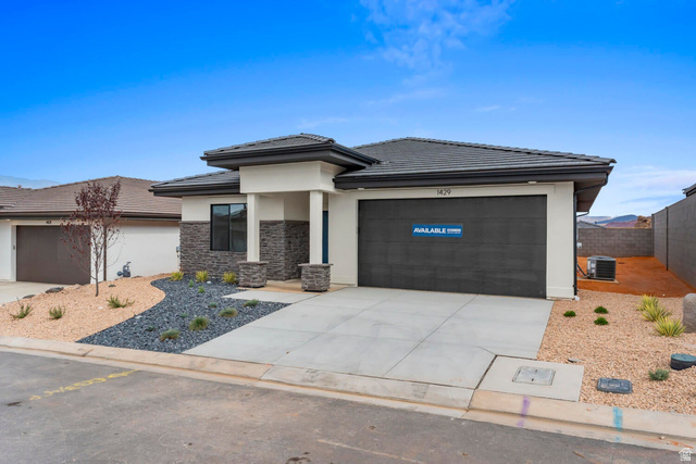 1624 South Staircase Way, Unit 4183 Washington, UT 84780 - Photo 2 of 47 Contemporary exterior featuring a split-level roofline, stone veneer accents, and a dark garage door