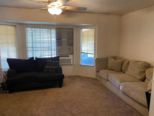 a living room with furniture and a large window