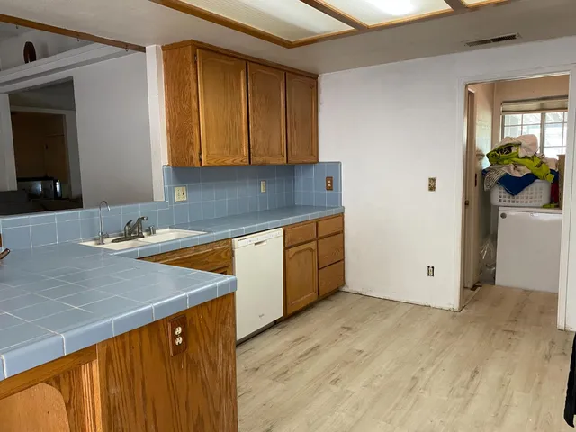 a view of a kitchen with a sink and cabinets