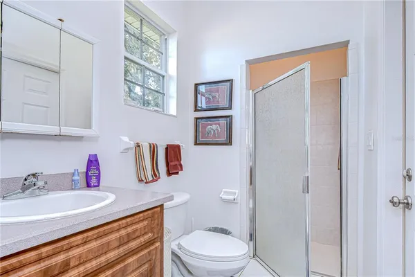 a bathroom with a granite countertop sink a mirror and a toilet