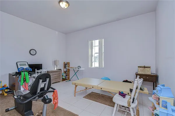 a living room with furniture a flat screen tv and a window