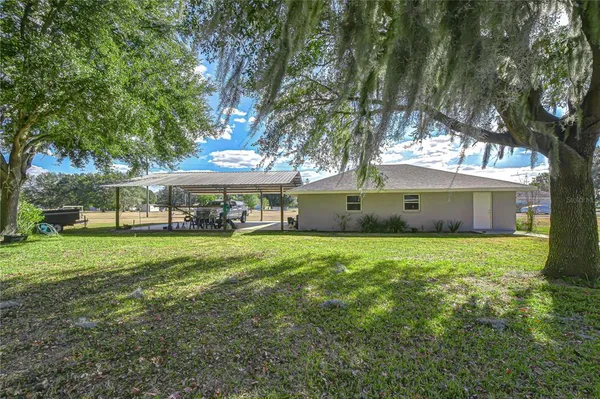 a front view of house with yard and outdoor seating