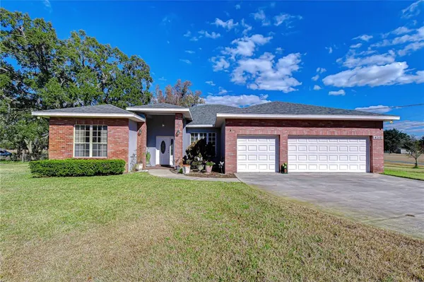 a view of a house with a yard and garage