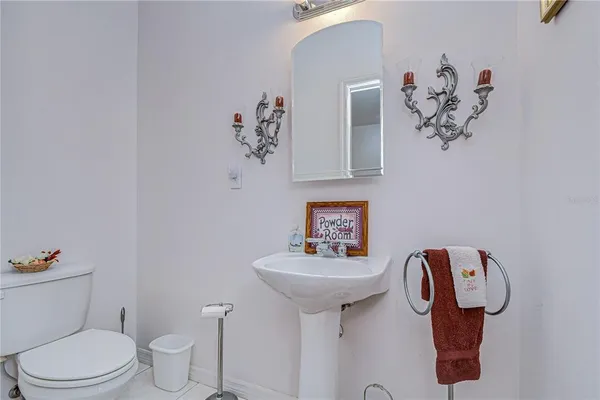 a bathroom with a sink mirror and toilet