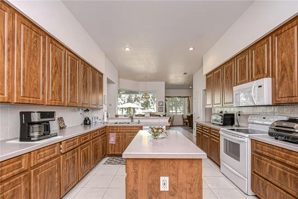 a kitchen with counter top space a sink stainless steel appliances and cabinets