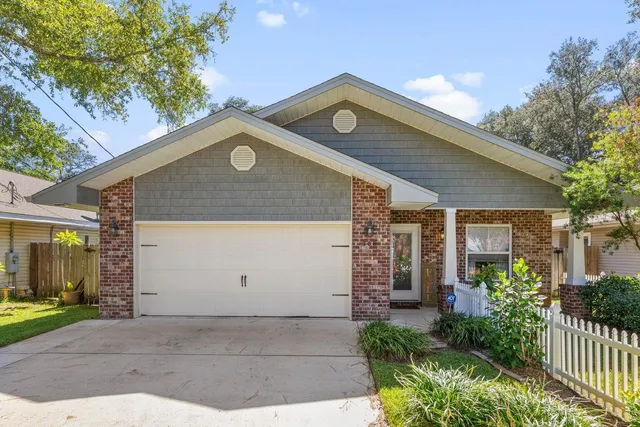 a front view of house with a garden