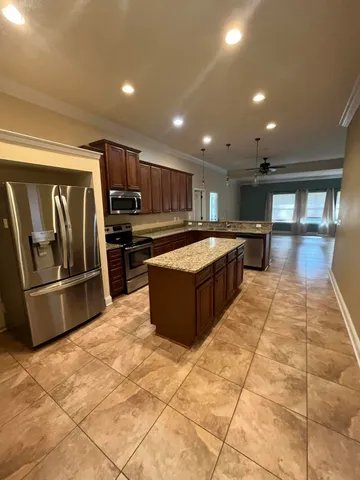 a large kitchen with stainless steel appliances lots of counter space