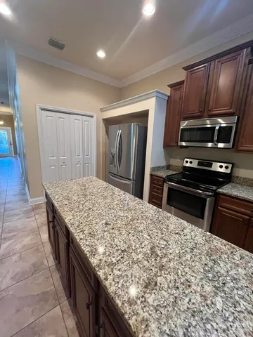 a kitchen with sink and refrigerator