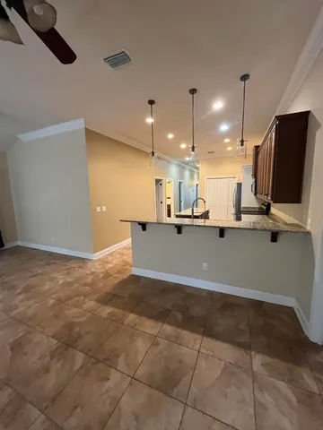 a view of kitchen with refrigerator and window