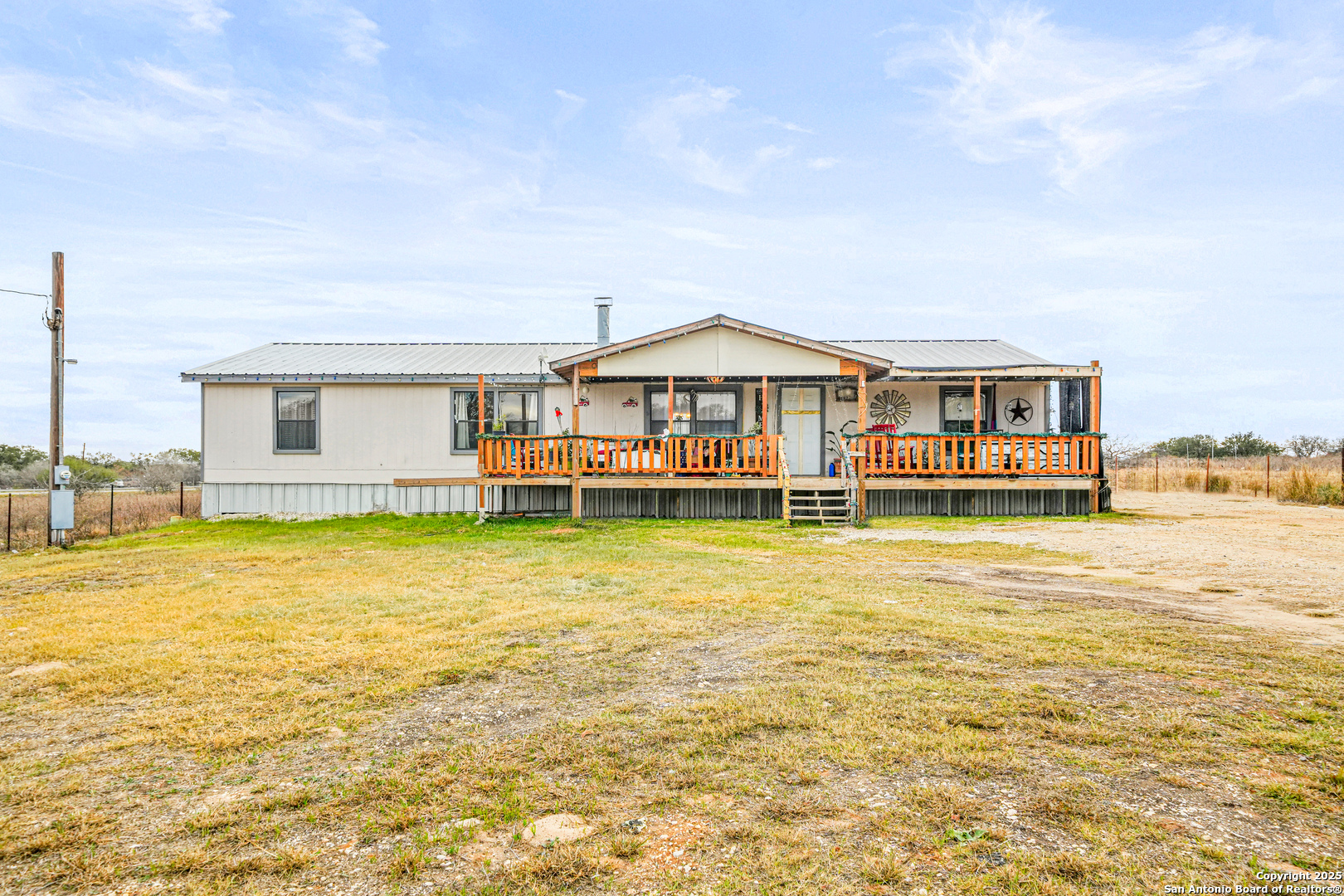 927 County Road 6846 Lytle, TX 78052 - Photo 1 of 21 a front view of a house with swimming pool having outdoor seating