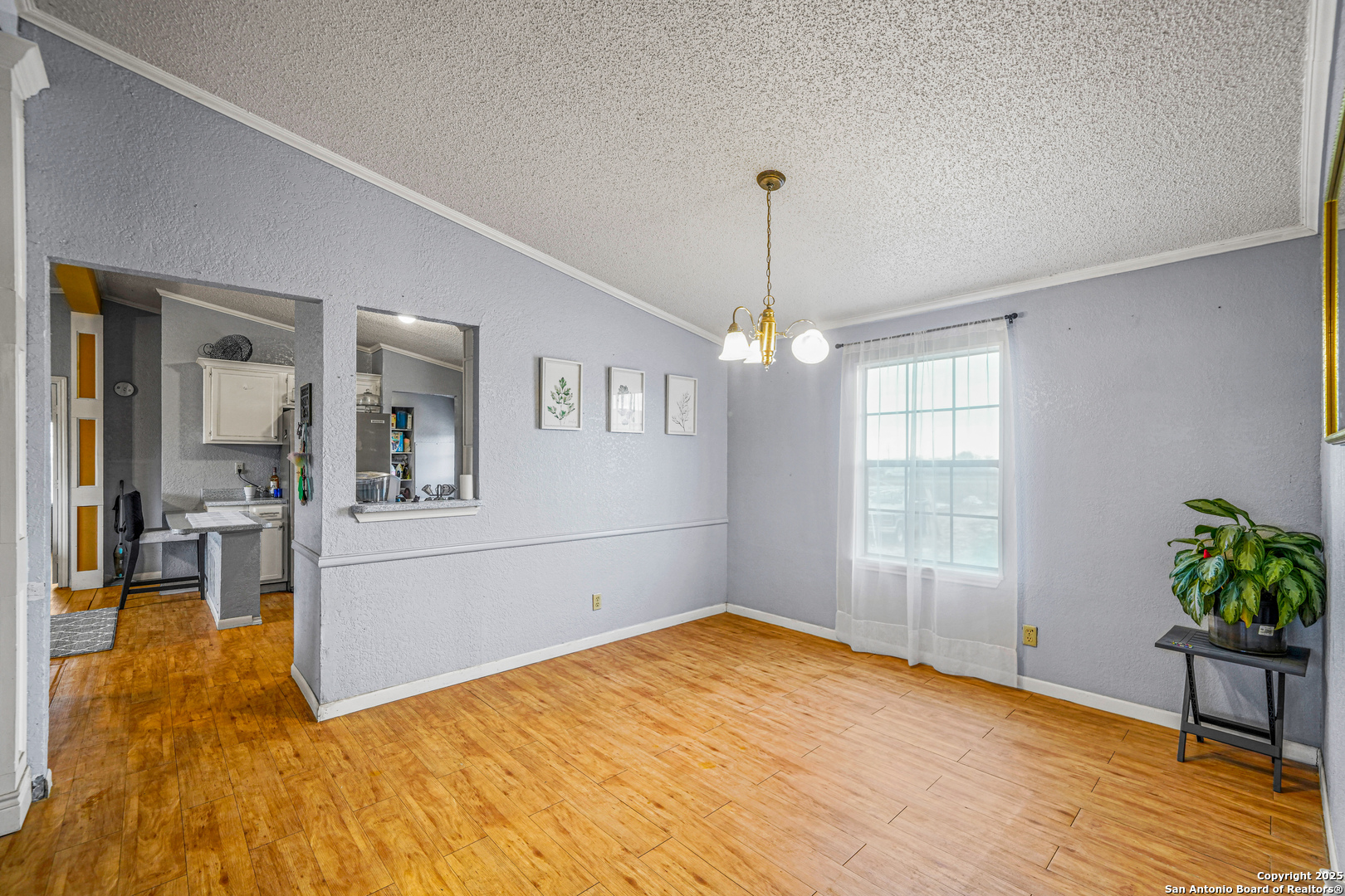 927 County Road 6846 Lytle, TX 78052 - Photo 11 of 21 a view of empty room with wooden floor and floor to ceiling window