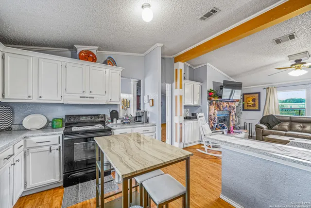 a kitchen with stainless steel appliances granite countertop a sink and cabinets