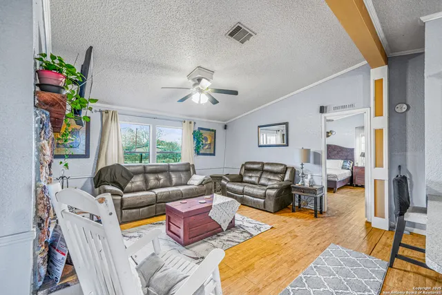 a living room with furniture fireplace and a large window