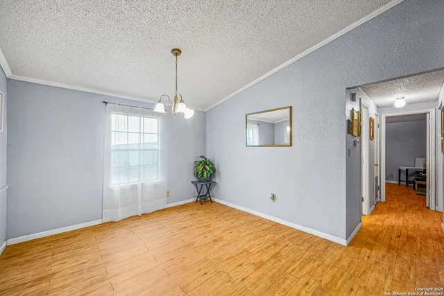 a view of empty room with window and ceiling fan