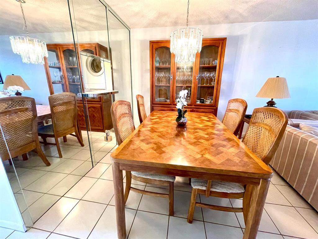 10444 Northwest 30th Court, Unit 409 Sunrise, FL 33322 - Photo 11 of 28 a view of a dining room with furniture and chandelier