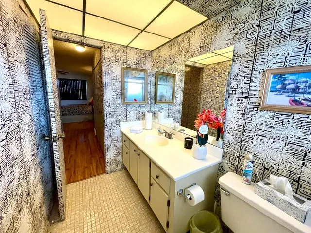 a bathroom with a sink mirror and a bathtub