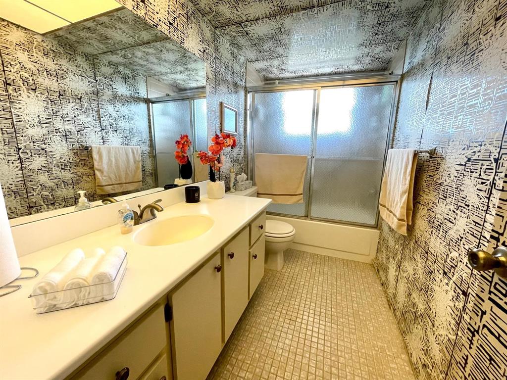 10444 Northwest 30th Court, Unit 409 Sunrise, FL 33322 - Photo 16 of 28 a bathroom with a sink mirror and a bathtub