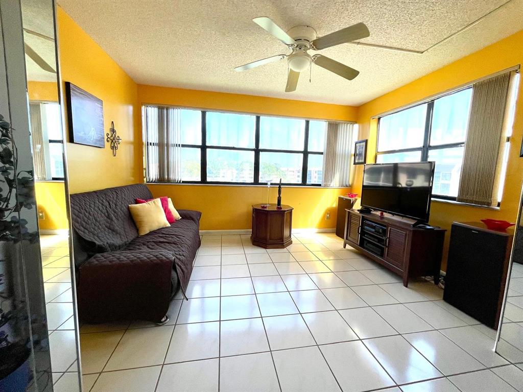 10444 Northwest 30th Court, Unit 409 Sunrise, FL 33322 - Photo 18 of 28 a living room with furniture and a flat screen tv