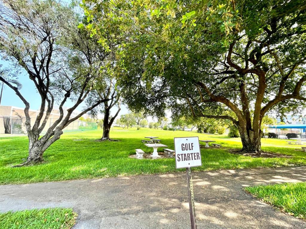 10444 Northwest 30th Court, Unit 409 Sunrise, FL 33322 - Photo 19 of 28 a sign board with yard in the back