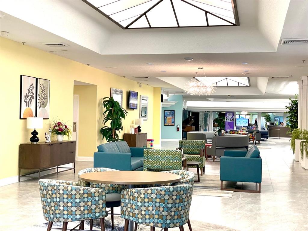 10444 Northwest 30th Court, Unit 409 Sunrise, FL 33322 - Photo 20 of 28 a living room with furniture and a fireplace