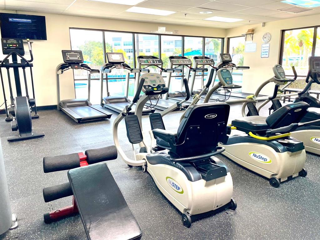 10444 Northwest 30th Court, Unit 409 Sunrise, FL 33322 - Photo 21 of 28 a living room with furniture gym equipment and a large window
