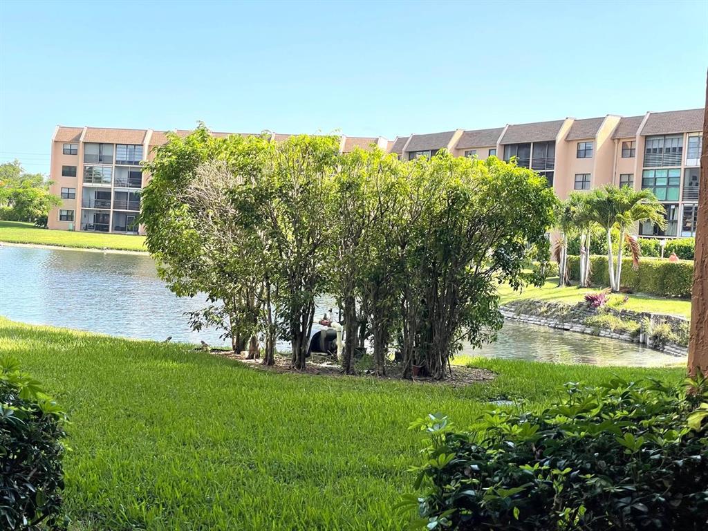 10444 Northwest 30th Court, Unit 409 Sunrise, FL 33322 - Photo 28 of 28 a view of yard with a building in the background
