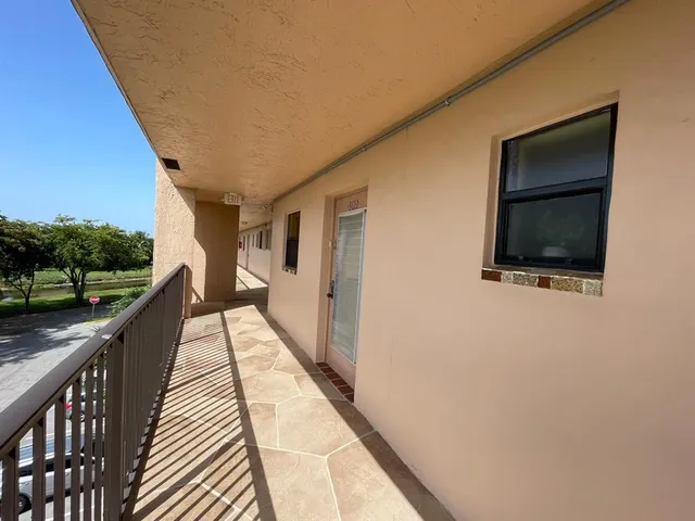a kitchen with a refrigerator a stove a sink and cabinets