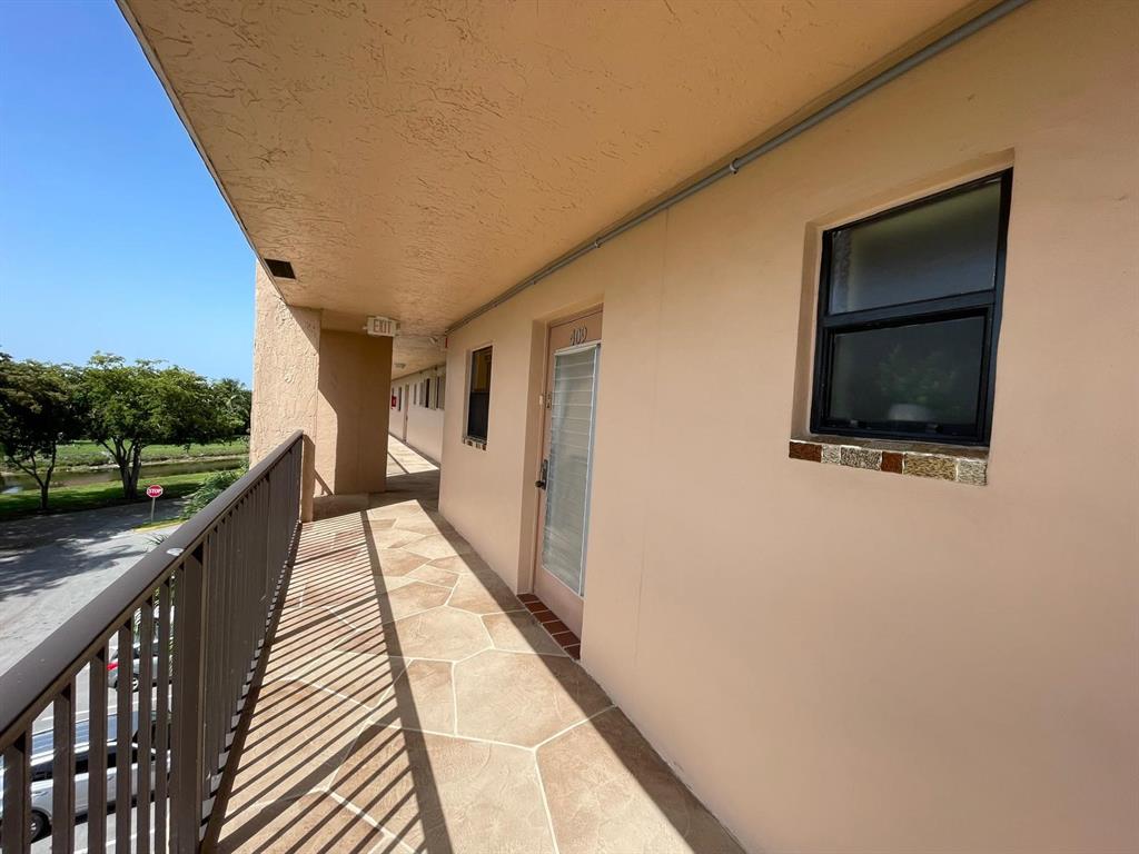 10444 Northwest 30th Court, Unit 409 Sunrise, FL 33322 - Photo 3 of 28 a view of balcony with wooden floor and stairs
