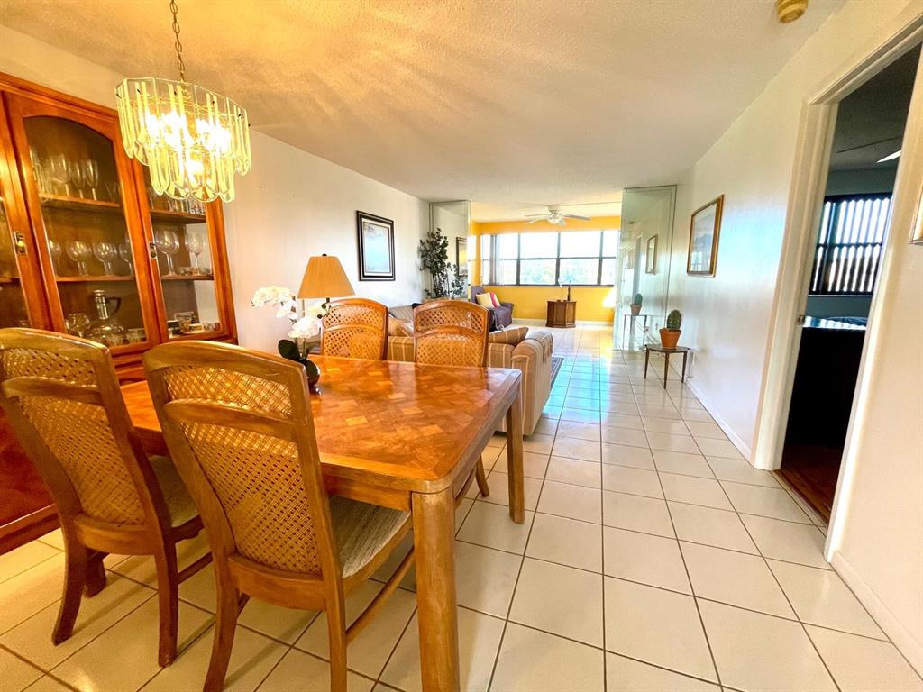 10444 Northwest 30th Court, Unit 409 Sunrise, FL 33322 - Photo 10 of 28 a dining room with furniture and large windows